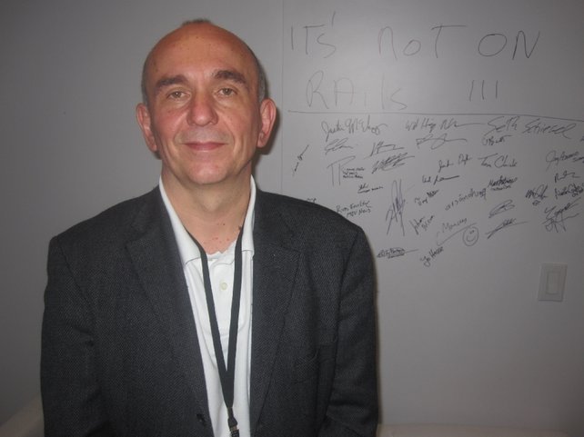 Peter Molyneux vor seiner "Das neue Fable ist spielbar"-Wand. In der Mitte unten hat auch Jo Hesse unterschrieben.